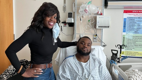 Mike Hollins in the hospital with his mother, Brenda.