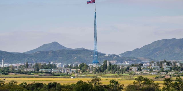 In this picture taken near the truce village of Panmunjom inside the demilitarized zone (DMZ) separating the two Koreas, a North Korean flag flutters in the wind at the propaganda village of Gijungdong in North Korea.