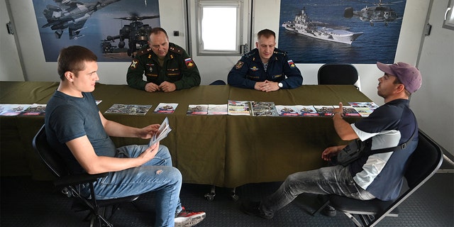 Men visit a mobile recruitment center for military service under contract in Rostov-on-Don, Russia, Sept. 17, 2022. 