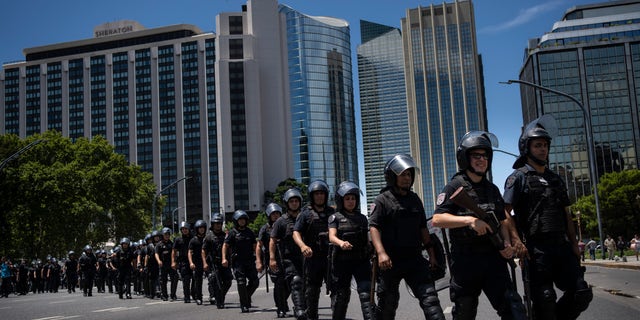 Buenos Aires city police cross the street after a demonstration against a summit held by the Community of Latin American and Caribbean States outside the hotel where leaders are meeting in Buenos Aires, Argentina, on Jan. 24, 2023. 