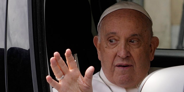 Pope Francis waves from his car as he arrives at The Vatican, Saturday, April 1, 2023, after receiving treatment at the Agostino Gemelli University Hospital for bronchitis, The Vatican said. 