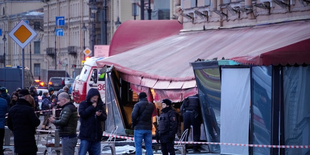 Russian officials are investigating the scene after a pro-Russian military blogger was killed in a cafe explosion that appeared to be an assassination.