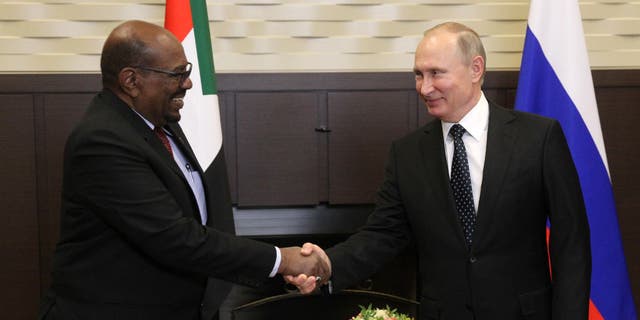 Russian President Vladimir Putin, right, greets former Sudanese President Omar al-Bashir during their meeting at Black Sea resort on Nov., 23, 2017 in Sochi, Russia. President al-Bashir was on his first state visit to Russia. Bashir was ousted in 2019.