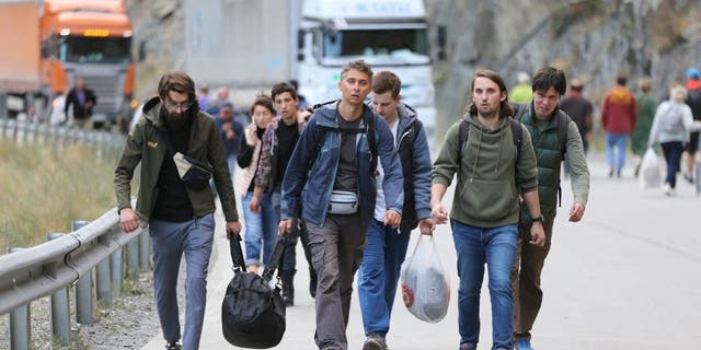 Russians are seen attempting to leave their country at the Kazbegi border crossing in Stepantsminda, Georgia, on Sept. 28, 2022. They were seeking to avoid a military call-up for the Russia-Ukraine war.
