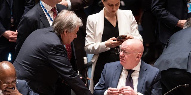 Secretary-General Antonio Guterres speaks with Ambassador of Russia Vassily Nebenzia before the start of the Security Council meeting on Ukraine at U.N. headquarters, Feb. 24, 2023.