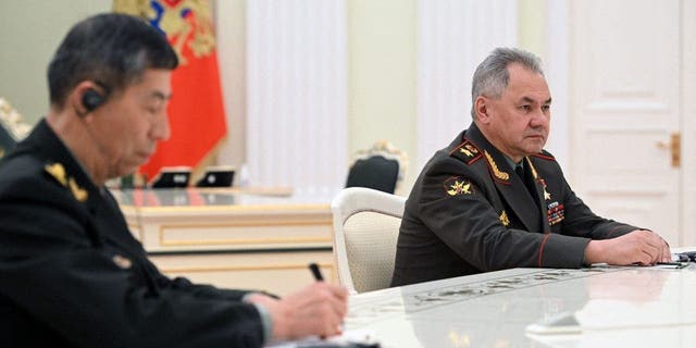 Russian Defense Minister Sergei Shoigu, right, attends a meeting of Russian President Vladimir Putin and Chinese Defense Minister Gen. Li Shangfu, left, at the Kremlin in Moscow, on April 16, 2023. 