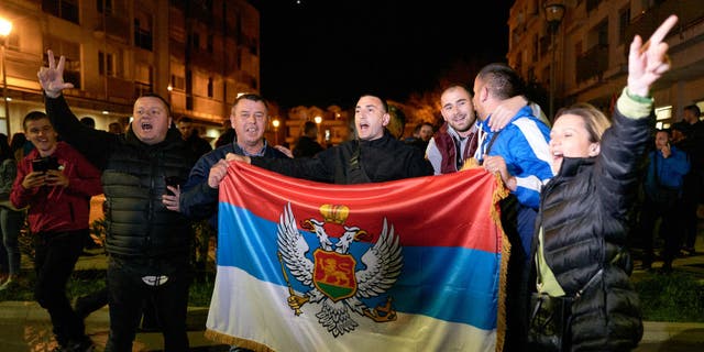 Montenegrin Serb nationalists hold an ancient flag of Montenegro as their candidate, Jakov Milatovic, won the second round of the presidential elections on April 2, 2023 in Podgorica, Montenegro.