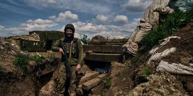A Ukrainian soldier smiles 