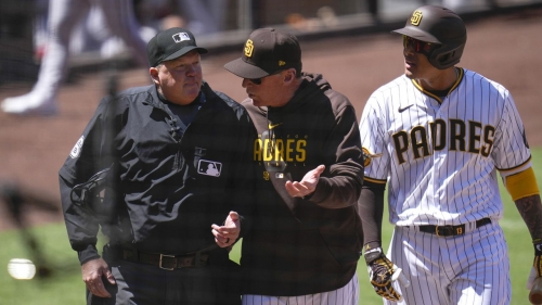 San Diego Padres manager Bob Melvin (center) talks with an umpire as Machado is being ejected.