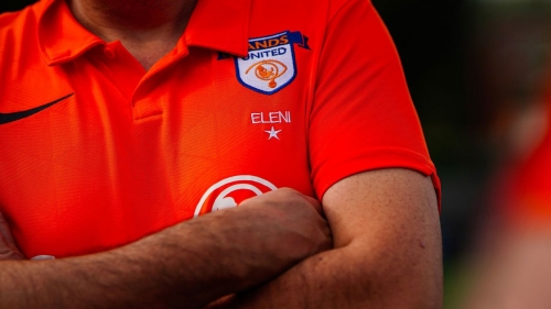 A Sands United FC London badge on a player's jersey.