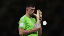 LUSAIL CITY, QATAR - DECEMBER 18: Emiliano Martinez of Argentina poses for a photo with the adidas Golden Glove trophy during the award ceremony following the FIFA World Cup Qatar 2022 Final match between Argentina and France at Lusail Stadium on December 18, 2022 in Lusail City, Qatar. (Photo by Clive Brunskill/Getty Images)