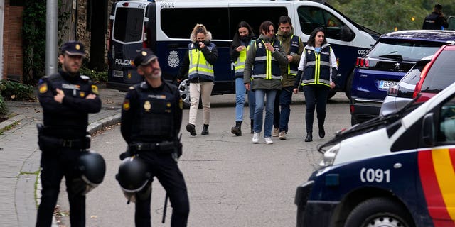 Police officers surround the Ukrainian embassy in Madrid, Spain, on Nov. 30, 2022, following reports of a blast at the embassy. A 74-year-old man was charged with terrorism for sending explosive letters to high-profile diplomatic figures.