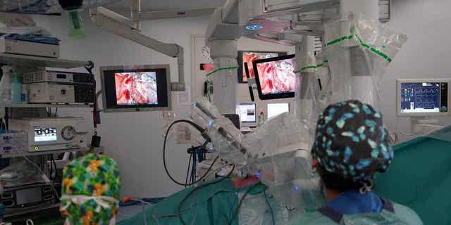 Medical staff from Vall d'Hebron University Hospital conducts a robotic lung operation in Barcelona, Spain, on April 3, 2023. The operation was conducted using a four-armed robot dubbed "Da Vinci."