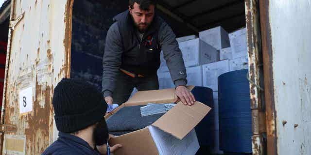 Border customs officials inspect a truck loaded with United Nations humanitarian aid for Syria following a devastating earthquake at the Bab al-Hawa border crossing with Turkey, on Feb. 10, 2023. A U.N. commission claims the international community and the Syrian government did not act quickly last month to help people in need in the northwest of Syria during the first days after the earthquake hit. 