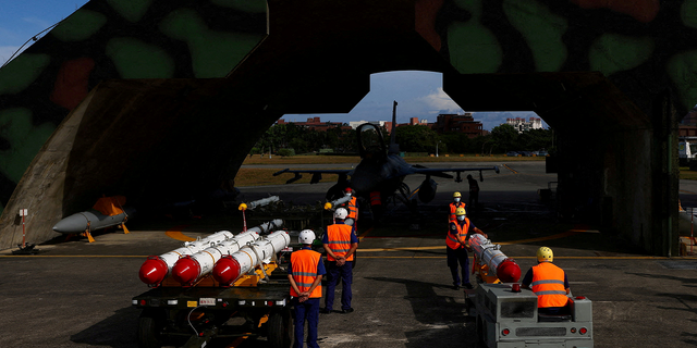 Taiwan air force personnel load U.S.-made Harpoon AGM-84 anti-ship missiles at a combat readiness mission during a press invited event at an airbase in Hualien, Taiwan, in August 2022. This version of the Harpoon missile is fired from the air.