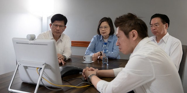 Taiwanese President Tsai Ing-wen attends a video call with senior members of government and security officials in Taipei, during her trip to Belize.