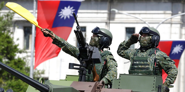 Taiwanese soldiers salute during National Day celebrations in front of the Presidential Building in Taipei, Taiwan.