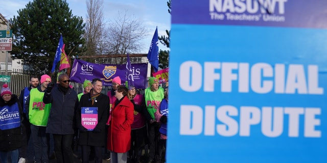 NASUWT leaders and teachers picket outside St. Andrew's RC Secondary School in Glasgow, Scotland, as they take strike action in a dispute over pay.