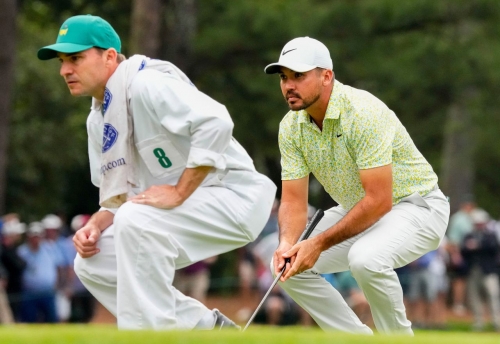 Jason Day and William Kane, caddie for Gordon Sargent, read the first green on Friday.