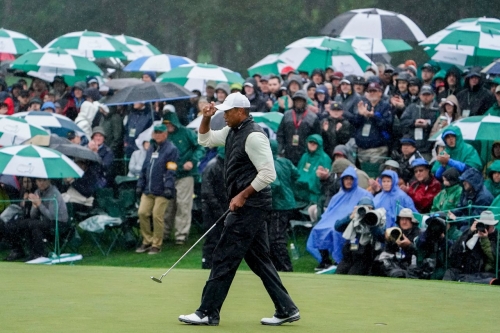 Tiger Woods walks the 18th green during the second round on Saturday, April 8.