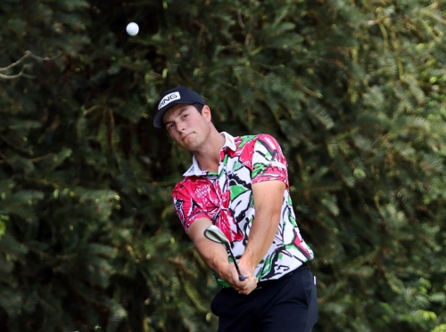 Viktor Hovland chips onto the 10th green Thursday. The Norwegian shot a 7-under 65 and shared the first-round lead with Koepka and Rahm.