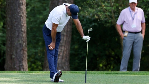 Woods reacts to his approach shot on the 11th hole.