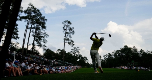 Brooks Koepka hits his tee shot on the 14th hole Thursday. Koepka shot a 7-under 65 to tie Hovland and Jon Rahm for the first-round lead.