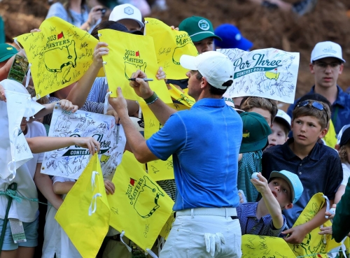 Rory McIlroy signs autographs after competing in the traditional par 3 contest that is held the day before the start of the tournament.