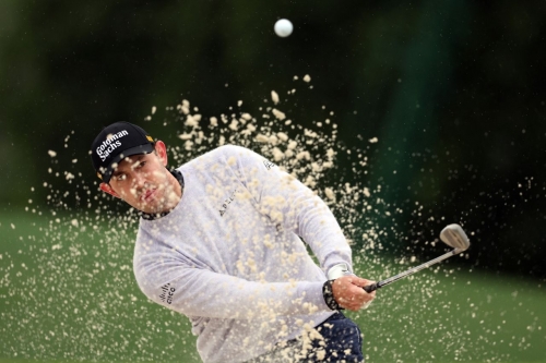 Patrick Cantlay plays a shot from a bunker on the 18th hole on Saturday. 