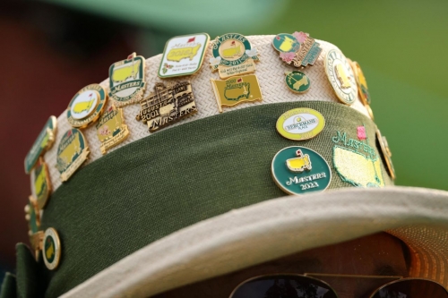Pins adorn a spectator's hat on Thursday.