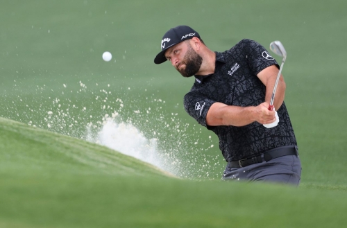 Jon Rahm plays out from the bunker on the second hole Friday.