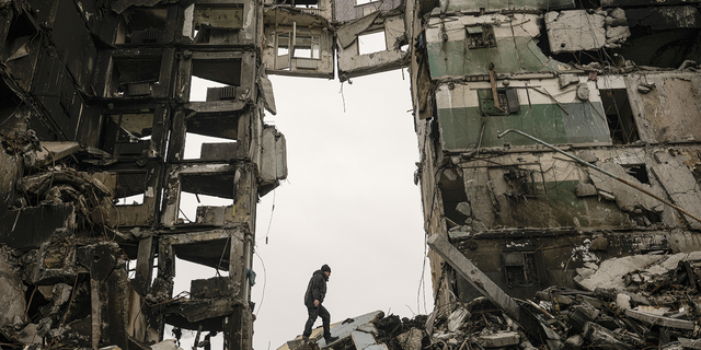 A resident looks for belongings in an apartment building destroyed during fighting between Ukrainian and Russian forces in Borodyanka, Ukraine.