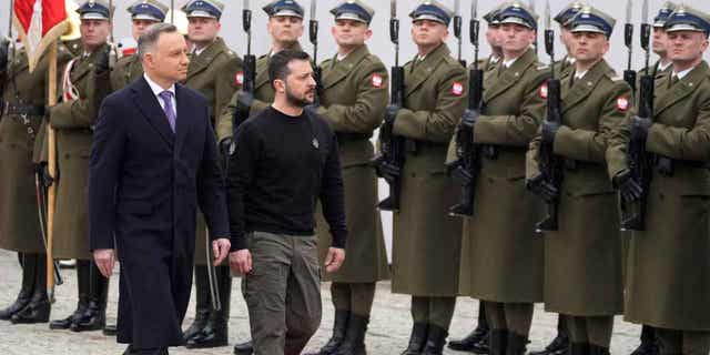 Ukrainian President Volodymyr Zelenskyy is welcomed by Poland's President Andrzej Duda, left, as they meet in Warsaw, Poland, on April 5, 2023. 