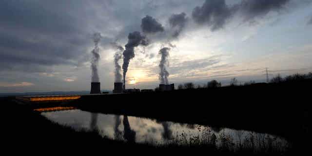 Smoke rises from chimneys of the Turow power plant near the town of Bogatynia, Poland, on Nov. 19, 2019. A scheme to develop small nuclear power reactors in Poland is moving forward, with an agreement between two U.S. government financial institutions and the Polish energy giant ORLEN.