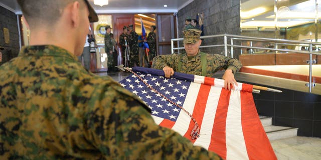 Members of US marines guards fold their national flag during the closing ceremony of the annual joint US-Philippines military exercise in Manila on May 19, 2017. 