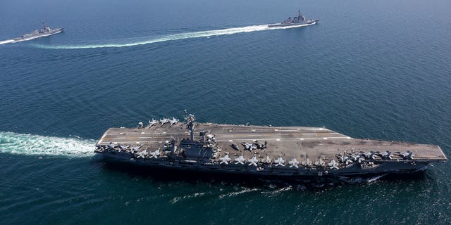 The U.S., Japanese and South Korean navies conduct joint military exercises.