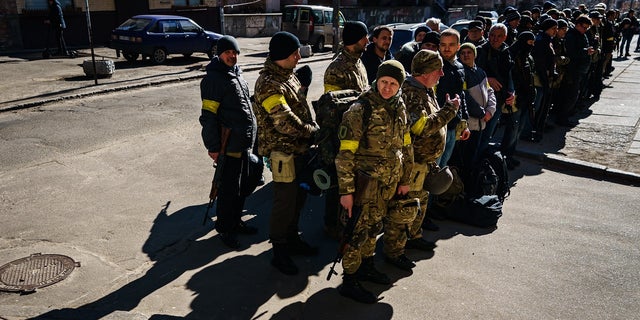 The soldier in the video was wearing a yellow armband similar to the one seen here worn by Ukraine's Territorial Defense Units in February 2022.