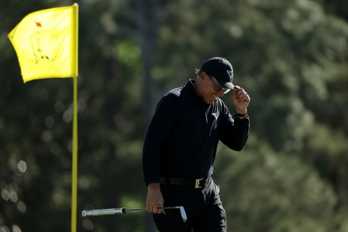 Mickelson reacts on the 18th green during the final round.