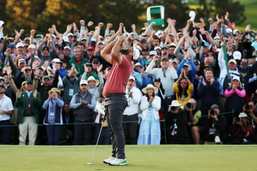 Rahm celebrates his win on the 18th green.