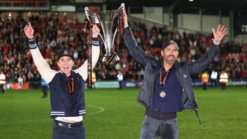 Wrexham owners Rob McElhenney and Ryan Reynolds celebrate after Wrexham won promotion back to the English Football League.