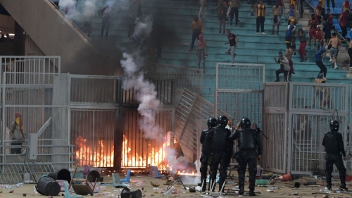 Esperance supporters clash with riot police during the CAF Champions League quarterfinal match between Esperance Sportive de Tunis and JS Kabylie.