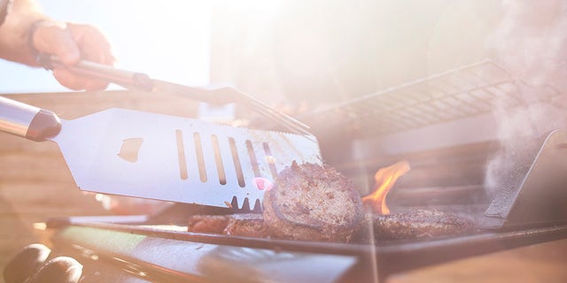 stock image of flipping hamburgers