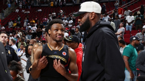 Bronny James (left) talks with his father LeBron James after the 2023 McDonalds High School All American Boys Game.