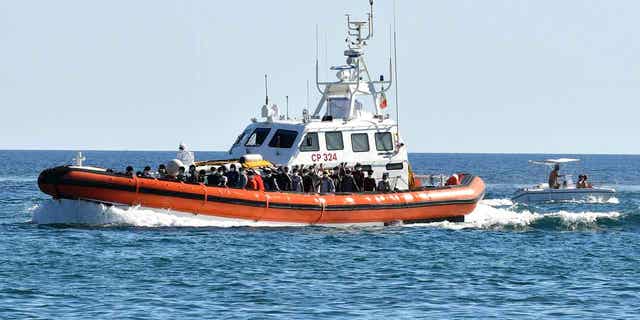 Italian coast guard boat with migrants aboard