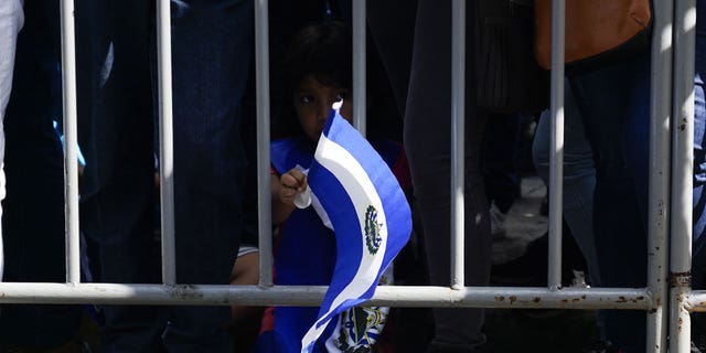 Child waving El Salvador flag