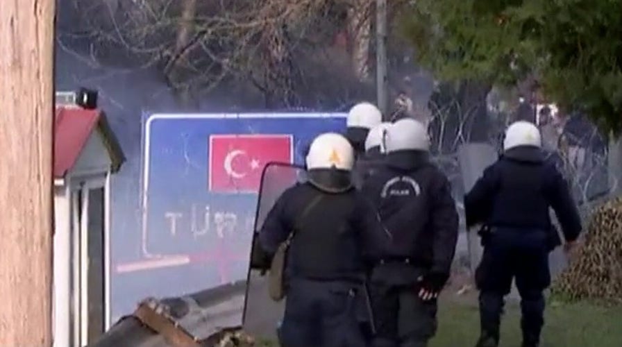Greece fires tear gas at migrants trying to cross border from Turkey