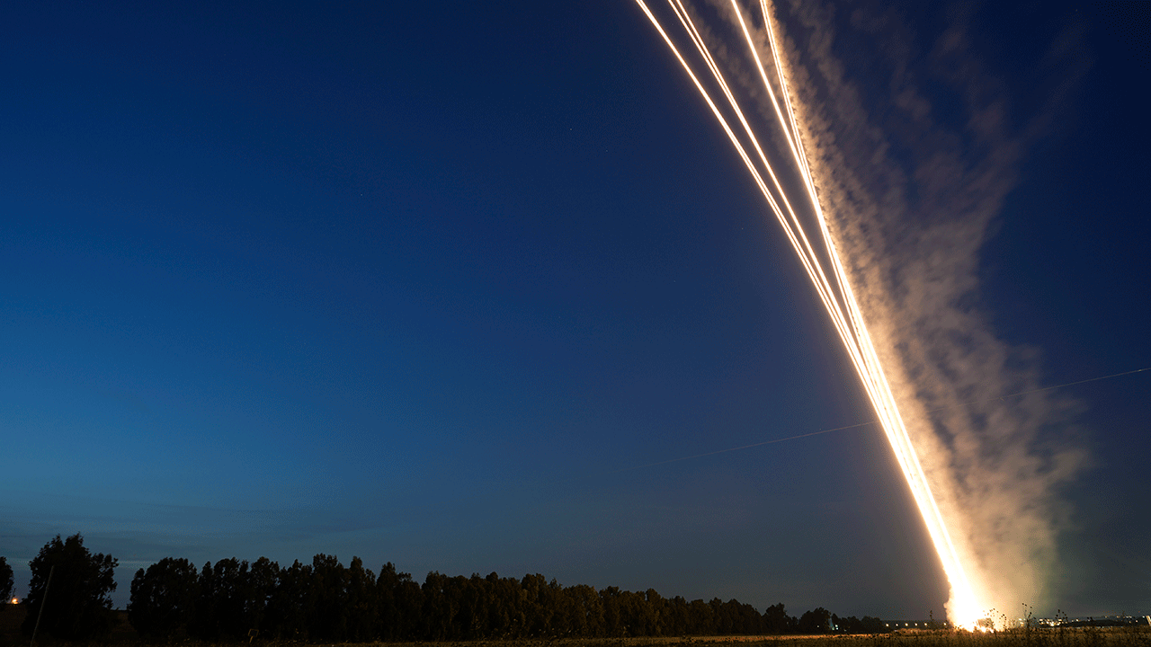 Rockets fire into the night