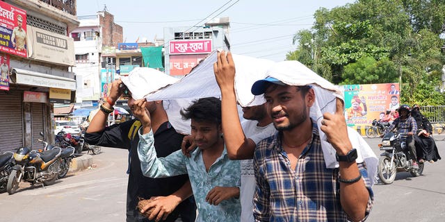 Indians use cloth to protect themselves from sun