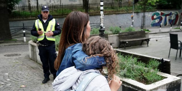 serbia parents holding children