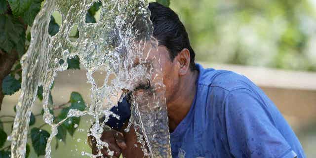 Person spraying water on his face